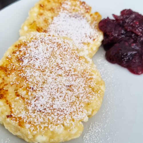 Curd pancakes on a plate with jam